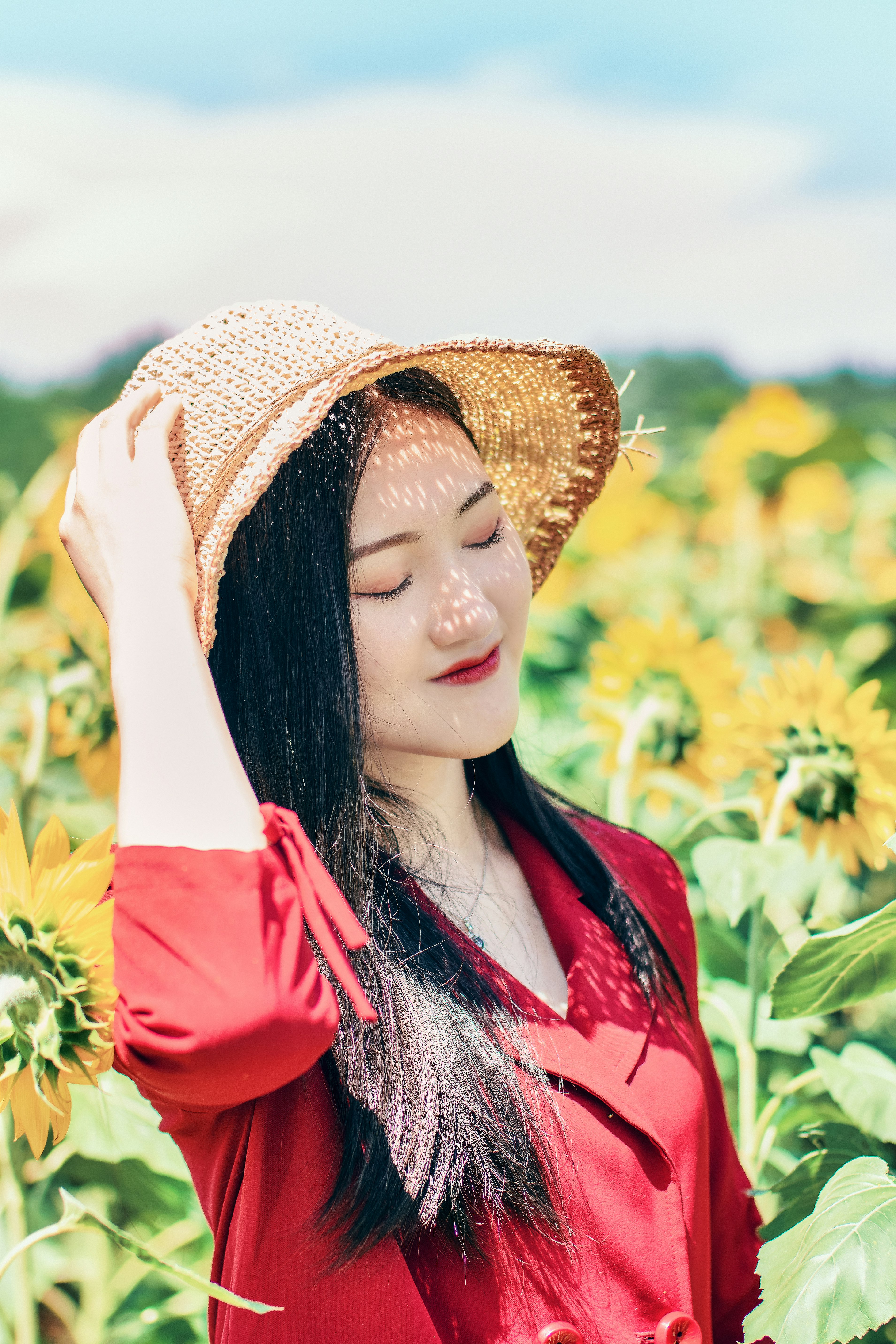 woman standing on sunflower field